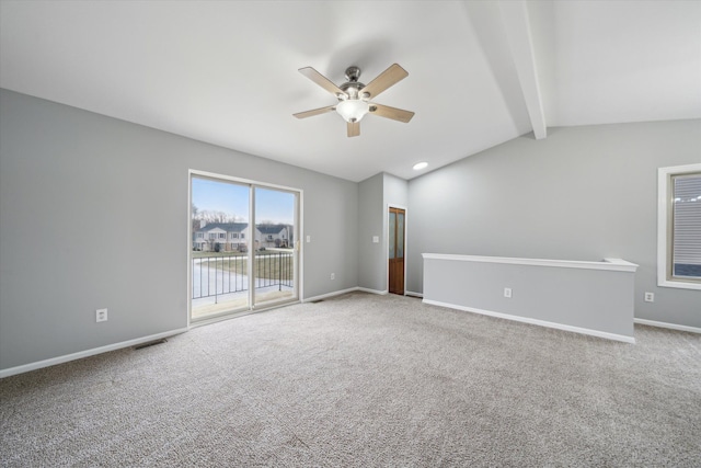 carpeted spare room featuring ceiling fan and vaulted ceiling with beams