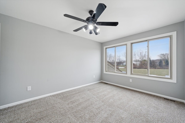 spare room featuring carpet flooring and ceiling fan