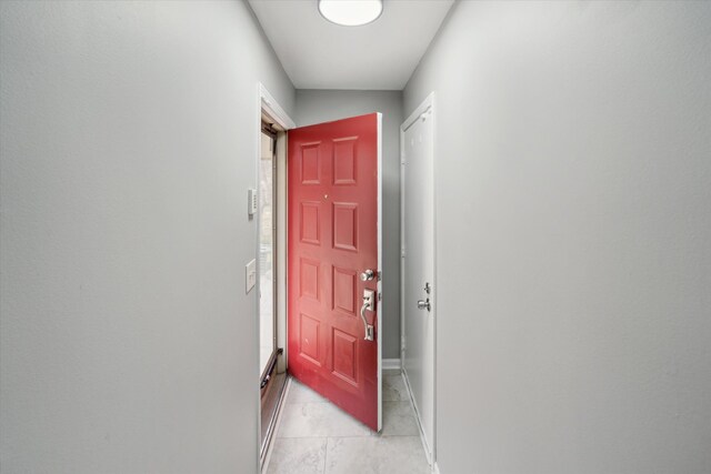 doorway to outside with light tile patterned floors