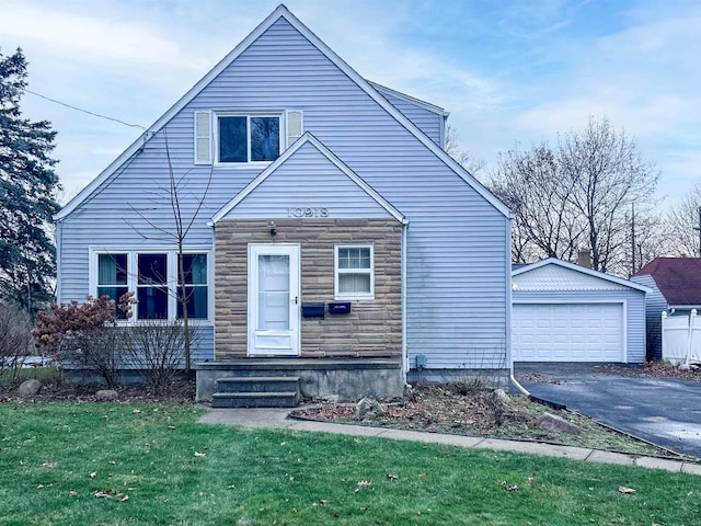 view of front of property with an outbuilding, a front yard, and a garage