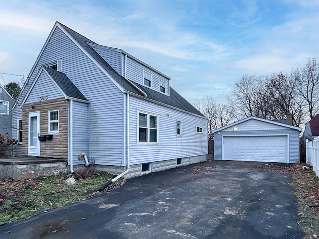 view of property exterior with a garage and an outbuilding