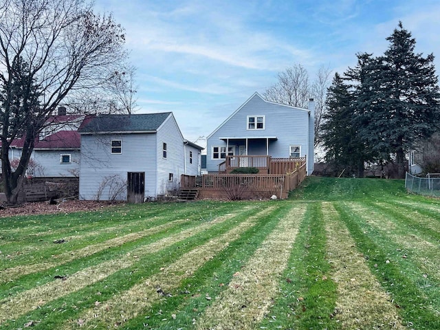 rear view of house with a yard and a deck