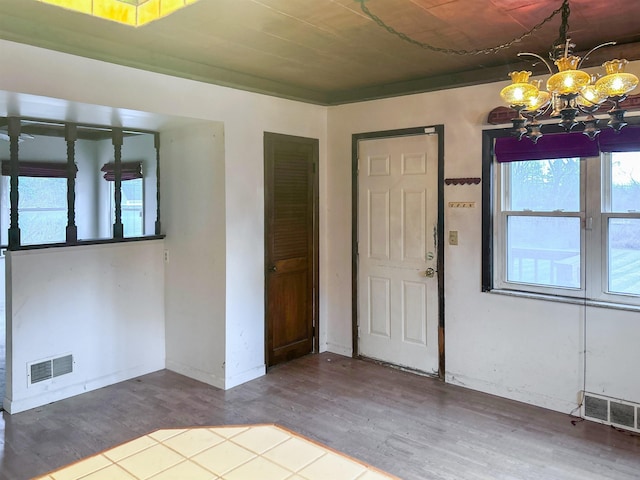 foyer entrance featuring a notable chandelier and wood-type flooring