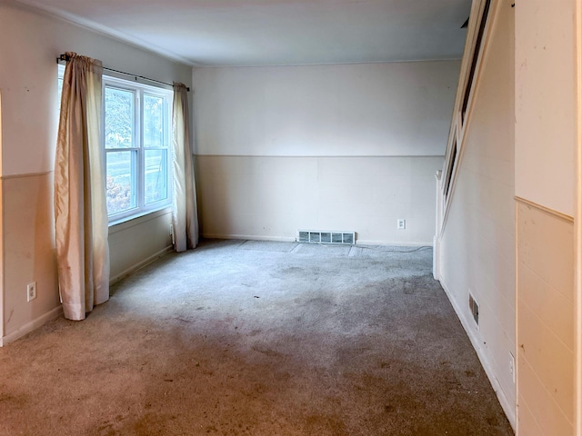 carpeted spare room with lofted ceiling