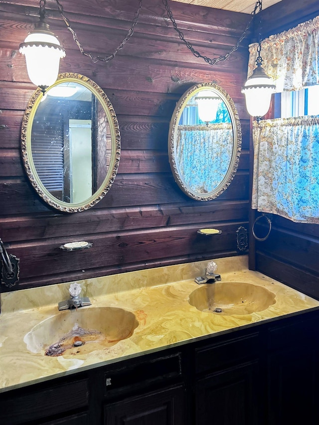 bathroom with vanity and wooden walls