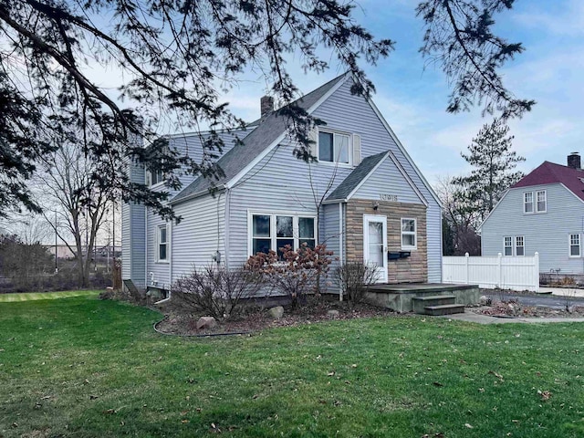 rear view of property with a lawn