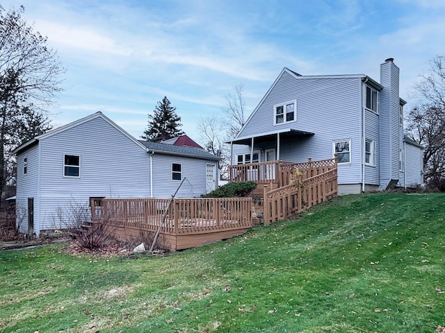 back of house with a lawn and a wooden deck