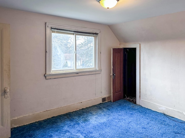 bonus room featuring dark carpet and lofted ceiling