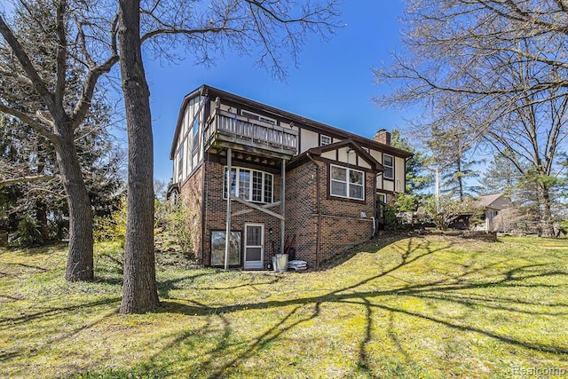 rear view of house featuring a yard