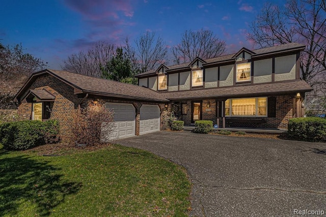 tudor house featuring a garage