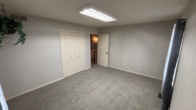 unfurnished bedroom featuring a closet and carpet