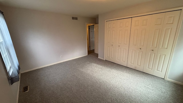 unfurnished bedroom featuring carpet floors and a closet