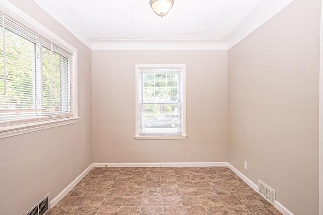 spare room with a textured ceiling and a healthy amount of sunlight