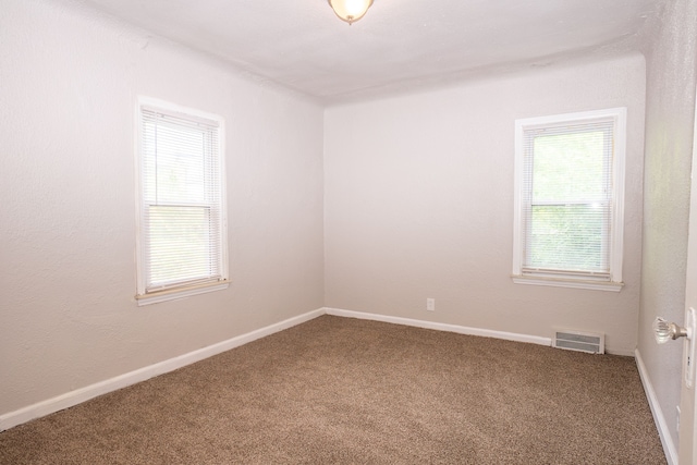 unfurnished room featuring carpet