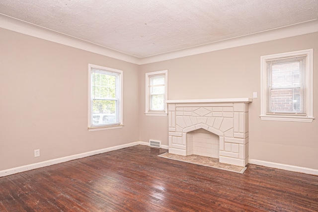 unfurnished living room featuring a textured ceiling and dark wood-type flooring