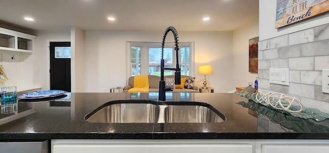 kitchen featuring white cabinets and dark stone counters