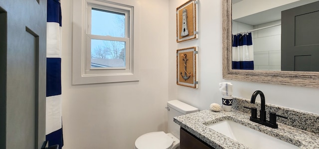 bathroom featuring vanity and toilet