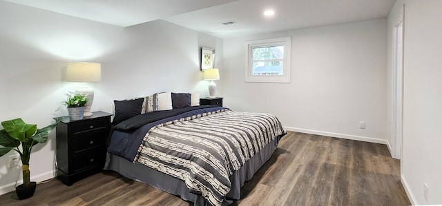 bedroom with dark hardwood / wood-style floors