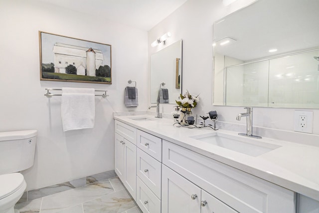 bathroom with vanity, toilet, and a shower with shower door