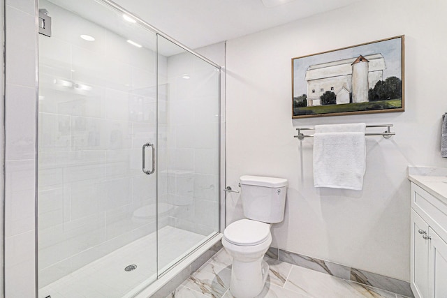 bathroom featuring a shower with door, vanity, and toilet