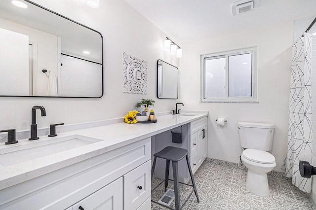 bathroom featuring tile patterned floors, vanity, a shower with shower curtain, and toilet