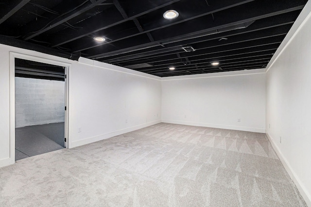 basement featuring light colored carpet