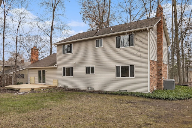 rear view of property featuring a yard, a patio, and cooling unit