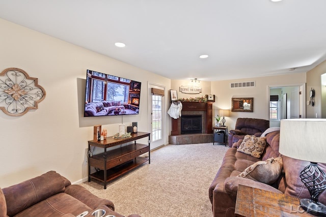 living room with carpet flooring and a tile fireplace