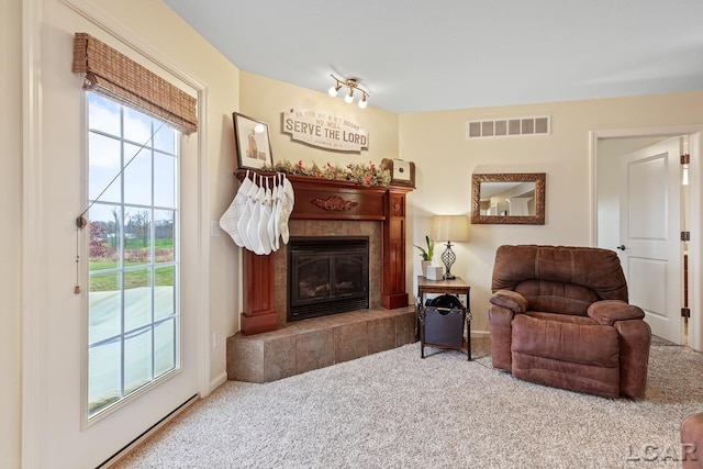 sitting room with carpet flooring and a tile fireplace