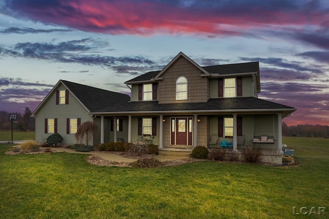 view of front of home with a yard and a porch