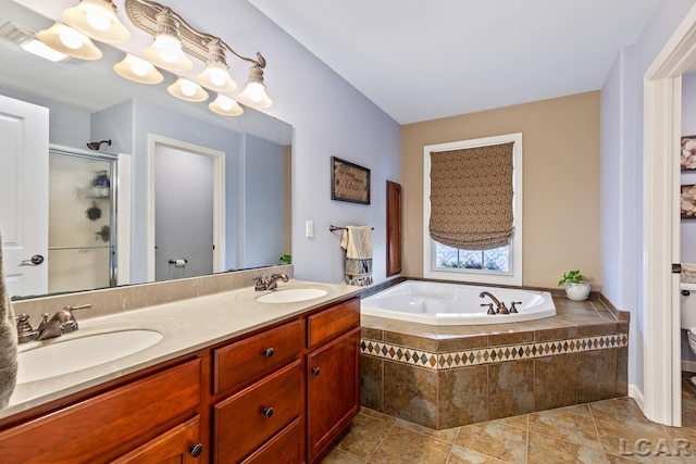 bathroom featuring tile patterned flooring, vanity, and shower with separate bathtub