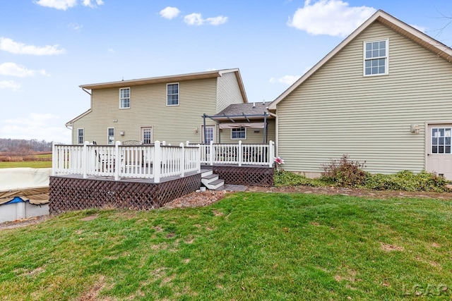 rear view of house with a lawn and a deck