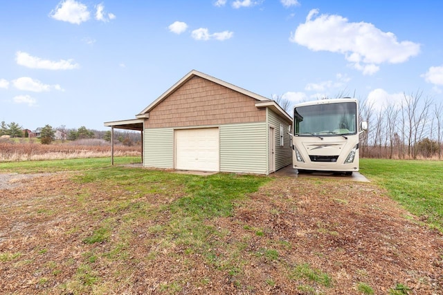 garage featuring a lawn and a carport