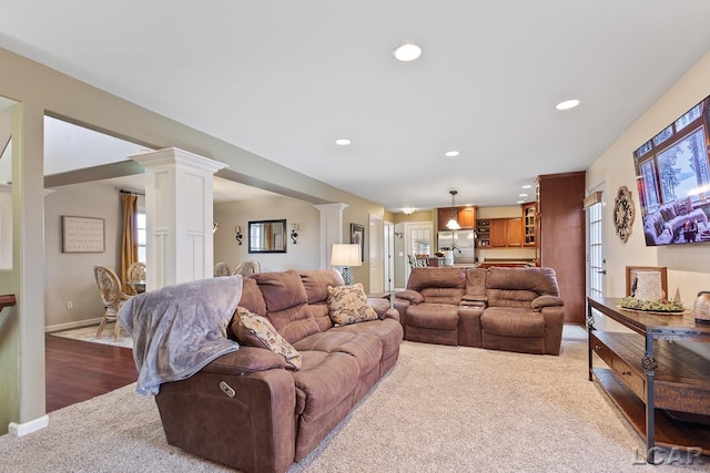 living room with hardwood / wood-style flooring and decorative columns