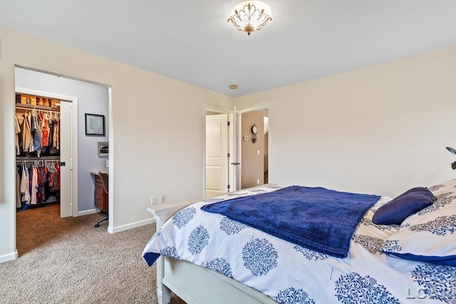 bedroom featuring light carpet, a spacious closet, and a closet