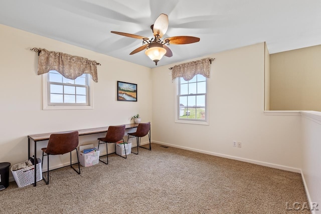 office with carpet floors, ceiling fan, and a healthy amount of sunlight