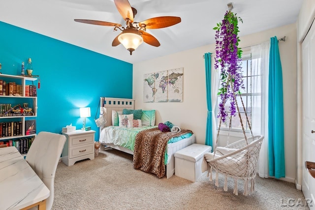 carpeted bedroom featuring a closet and ceiling fan