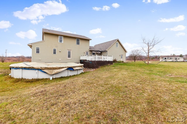 back of house with a yard and a pool side deck