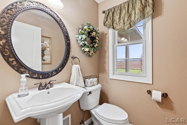 bathroom with toilet and sink