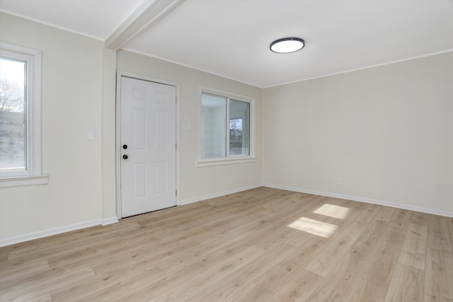 foyer entrance featuring light hardwood / wood-style floors and ornamental molding