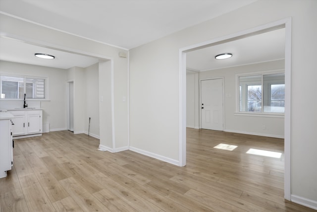 interior space with light hardwood / wood-style floors and sink