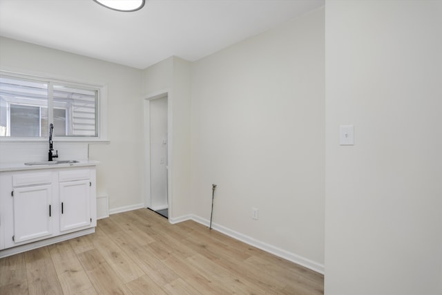 interior space with sink and light wood-type flooring