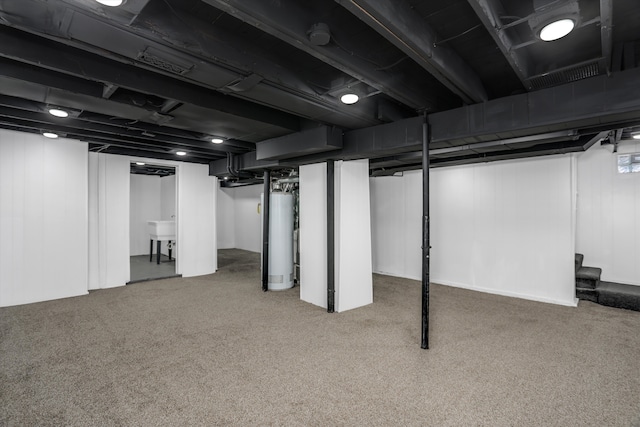 basement featuring carpet floors and gas water heater