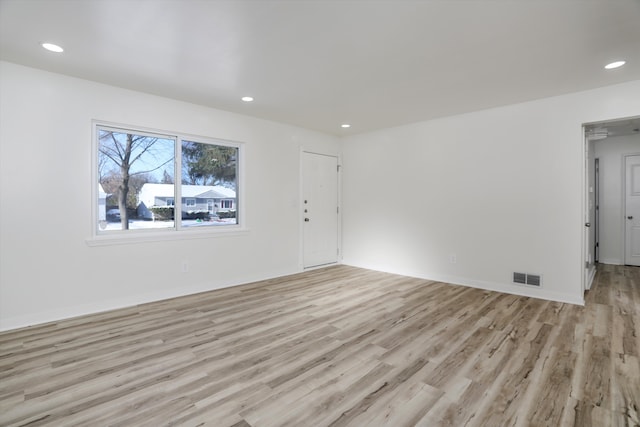 unfurnished room with light hardwood / wood-style floors