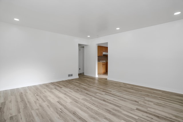 spare room with light hardwood / wood-style floors