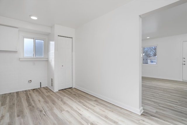 empty room with light hardwood / wood-style flooring