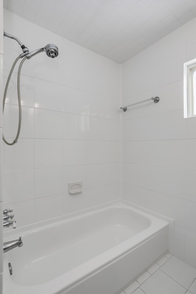 bathroom featuring tile patterned flooring and tiled shower / bath combo