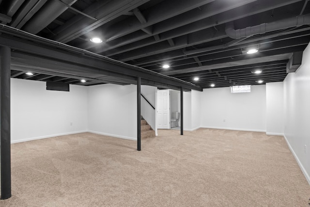 basement featuring light carpet