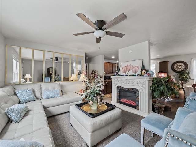 carpeted living room with ceiling fan