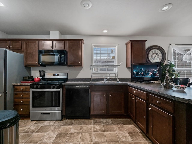 kitchen featuring sink, black appliances, and dark brown cabinets